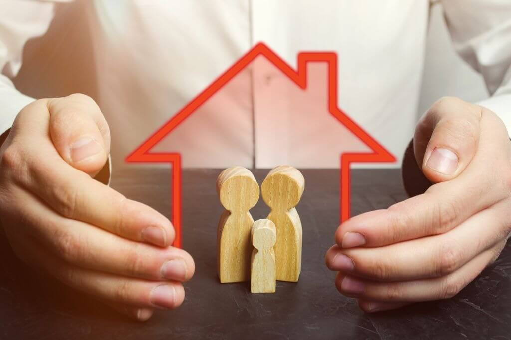bigstock-Insurance-Agent-Holds-Hands-Ov-275571802